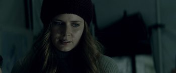 Movie still from “Man of Steel” (2013), directed by Zack Snyder – A person wearing a sweater and a hat; Close Up shot, Over the shoulder angle