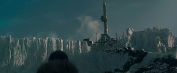 Movie still from “Man of Steel” (2013), directed by Zack Snyder – A tall building on top of a snow covered hill; Extreme Wide shot, Low angle