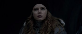 Movie still from “Man of Steel” (2013), directed by Zack Snyder – A person with long hair wearing a hat; Close Up shot, Over the shoulder angle