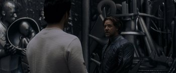 Movie still from “Man of Steel” (2013), directed by Zack Snyder – A man standing next to another man in front of a mirror; Medium shot, Over the shoulder angle