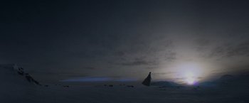 Movie still from “Man of Steel” (2013), directed by Zack Snyder – A person standing in the middle of a field at night; Extreme Wide shot, Low angle