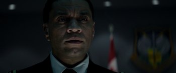 Movie still from “Man of Steel” (2013), directed by Zack Snyder – A person wearing a suit and tie; Close Up shot, Low angle