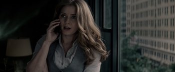 Movie still from “Man of Steel” (2013), directed by Zack Snyder – A woman talking on a cell phone in a dark room; Close Up shot, Over the shoulder angle