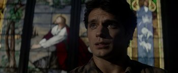 Movie still from “Man of Steel” (2013), directed by Zack Snyder – A person looking up at a painting; Close Up shot, Over the shoulder angle