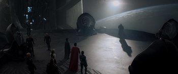 Movie still from “Man of Steel” (2013), directed by Zack Snyder – A group of people standing in a dark space; Extreme Wide shot, High angle