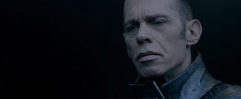 Movie still from “Man of Steel” (2013), directed by Zack Snyder – A man with a bald head is looking at the camera; Close Up shot, Over the shoulder angle