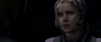 Movie still from “Man of Steel” (2013), directed by Zack Snyder – A woman wearing a head piece and looking at the camera; Close Up shot, Over the shoulder angle