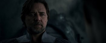 Movie still from “Man of Steel” (2013), directed by Zack Snyder – A person with a beard and mustache; Close Up shot, Over the shoulder angle