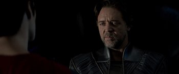 Movie still from “Man of Steel” (2013), directed by Zack Snyder – A person wearing a suit; Close Up shot, Over the shoulder angle