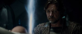 Movie still from “Man of Steel” (2013), directed by Zack Snyder – A person with a sword in a room; Close Up shot, Over the shoulder angle