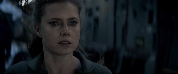 Movie still from “Man of Steel” (2013), directed by Zack Snyder – A person wearing a jacket with smoke coming out of it; Close Up shot, Over the shoulder angle