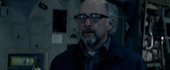 Movie still from “Man of Steel” (2013), directed by Zack Snyder – An older man wearing glasses and a jacket; Close Up shot, Over the shoulder angle