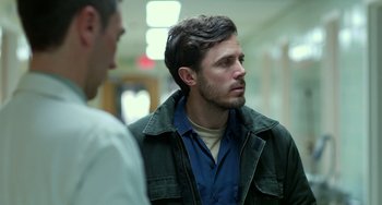 Movie still from “Manchester by the Sea” (2016), directed by Kenneth Lonergan – A man in a blue shirt and a man in a green jacket; Close Up shot, Over the shoulder angle