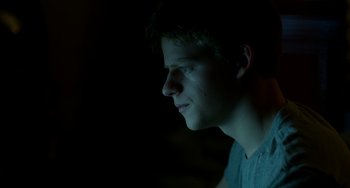 Movie still from “Manchester by the Sea” (2016), directed by Kenneth Lonergan – A young man is looking into the distance; Close Up shot, Over the shoulder angle