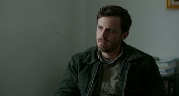 Movie still from “Manchester by the Sea” (2016), directed by Kenneth Lonergan – A person sitting in a chair; Close Up shot, Over the shoulder angle