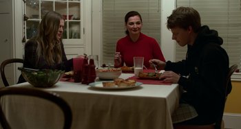 Movie still from “Manchester by the Sea” (2016), directed by Kenneth Lonergan – A group of people sitting around a table eating food; Medium shot, Over the shoulder angle