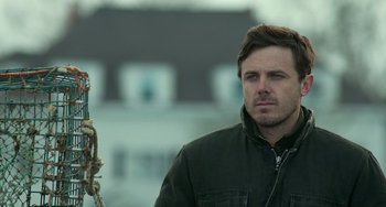 Movie still from “Manchester by the Sea” (2016), directed by Kenneth Lonergan – A person wearing a jacket; Close Up shot, Over the shoulder angle