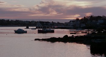 Movie still from “Manchester by the Sea” (2016), directed by Kenneth Lonergan – A body of water that has a boat in the water; Extreme Wide shot, High angle