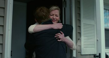 Movie still from “Manchester by the Sea” (2016), directed by Kenneth Lonergan – A woman is hugging a man outside of a house; Medium shot, Over the shoulder angle