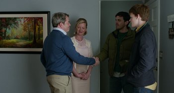 Movie still from “Manchester by the Sea” (2016), directed by Kenneth Lonergan – Two men and a woman shaking hands in a room; Medium shot, Over the shoulder angle