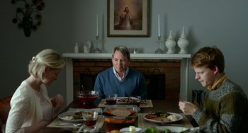Movie still from “Manchester by the Sea” (2016), directed by Kenneth Lonergan – A man sitting at a table with a plate of food in front of him; Medium shot, Over the shoulder angle