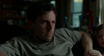 Movie still from “Manchester by the Sea” (2016), directed by Kenneth Lonergan – A person sitting in a chair; Close Up shot, Low angle