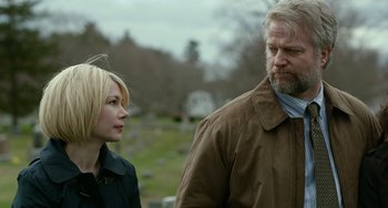 Movie still from “Manchester by the Sea” (2016), directed by Kenneth Lonergan – A man and a woman standing next to each other in a cemetery; Close Up shot, Over the shoulder angle