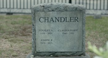 Movie still from “Manchester by the Sea” (2016), directed by Kenneth Lonergan – A headstone for a person who died in a car accident; Extreme Close Up shot, High angle