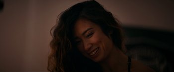 Movie still from “Margaux” (2022), directed by Steven C. Miller – A person with long hair smiling; Close Up shot, High angle