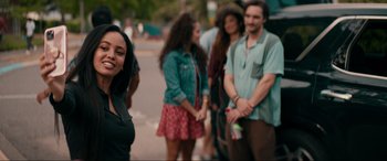 Movie still from “Margaux” (2022), directed by Steven C. Miller – A group of people standing on the side of the street; Medium shot, Over the shoulder angle