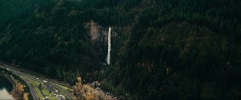 Movie still from “Margaux” (2022), directed by Steven C. Miller – A view of a waterfall in the middle of a forest; Extreme Wide shot, High angle