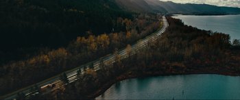 Movie still from “Margaux” (2022), directed by Steven C. Miller – An aerial view of a highway going through a forest; Extreme Wide shot, High angle