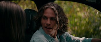 Movie still from “Margaux” (2022), directed by Steven C. Miller – A person in a car with long hair; Close Up shot, Over the shoulder angle