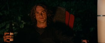 Movie still from “Margaux” (2022), directed by Steven C. Miller – A man sitting in a chair looking into the distance; Close Up shot, Over the shoulder angle