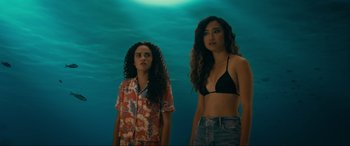 Movie still from “Margaux” (2022), directed by Steven C. Miller – Two young women standing in front of a body of water; Medium shot, Low angle
