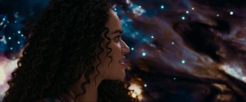 Movie still from “Margaux” (2022), directed by Steven C. Miller – A person with curly black hair; Close Up shot, Over the shoulder angle