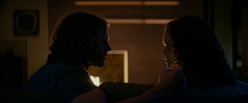 Movie still from “Margaux” (2022), directed by Steven C. Miller – A man and a woman face to face in a dark room; Close Up shot, Over the shoulder angle