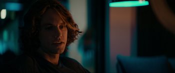 Movie still from “Margaux” (2022), directed by Steven C. Miller – A person sitting in a room; Close Up shot, Over the shoulder angle