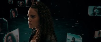 Movie still from “Margaux” (2022), directed by Steven C. Miller – A young woman with long curly brown hair looking to her left; Close Up shot, Low angle