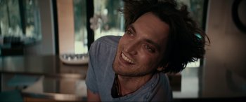 Movie still from “Margaux” (2022), directed by Steven C. Miller – A person with a beard smiling; Close Up shot, Low angle