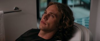 Movie still from “Margaux” (2022), directed by Steven C. Miller – A person with long curly hair; Close Up shot, Over the shoulder angle