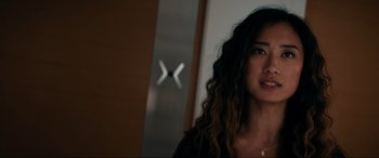 Movie still from “Margaux” (2022), directed by Steven C. Miller – A person with long curly hair; Close Up shot, Over the shoulder angle