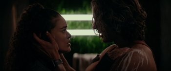 Movie still from “Margaux” (2022), directed by Steven C. Miller – A man and a woman are looking into each others eyes; Close Up shot, Over the shoulder angle