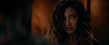 Movie still from “Margaux” (2022), directed by Steven C. Miller – A person with long curly hair; Close Up shot, Over the shoulder angle