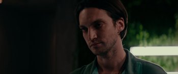 Movie still from “Margaux” (2022), directed by Steven C. Miller – A person wearing a green shirt; Close Up shot, Low angle