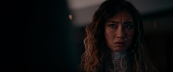 Movie still from “Margaux” (2022), directed by Steven C. Miller – A person with long curly hair; Close Up shot, Over the shoulder angle