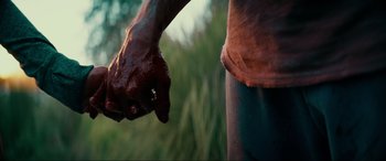 Movie still from “Margaux” (2022), directed by Steven C. Miller – A man holding his hand out to a woman; Extreme Close Up shot, Low angle