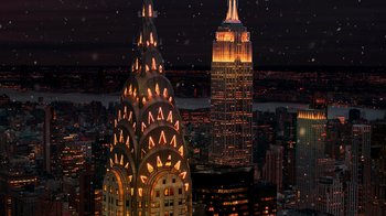 A view of the empire state building and the chrysler building at night