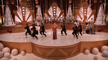 A group of people standing on a stage in a room