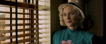 Movie still from “Marlowe” (2022), directed by Neil Jordan – A woman in a blue shirt wearing a white hat; Close Up shot, Low angle